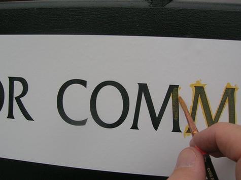 Gold Leaf on a Door — sign being fabricated on the bench by Hale Custom Signs
