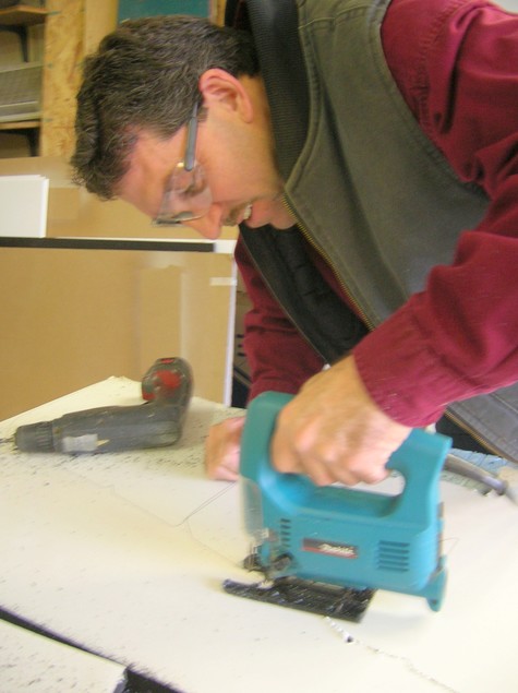 Hand-sawing letters at the bench — sign fabrication in the Gill, MA shop
