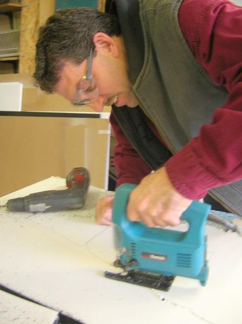 Hand Sawing letters — sign being fabricated on the bench by Hale Custom Signs