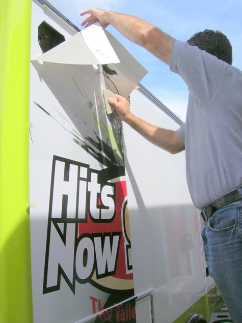Hits Now 94.3 — sign being fabricated on the bench by Hale Custom Signs