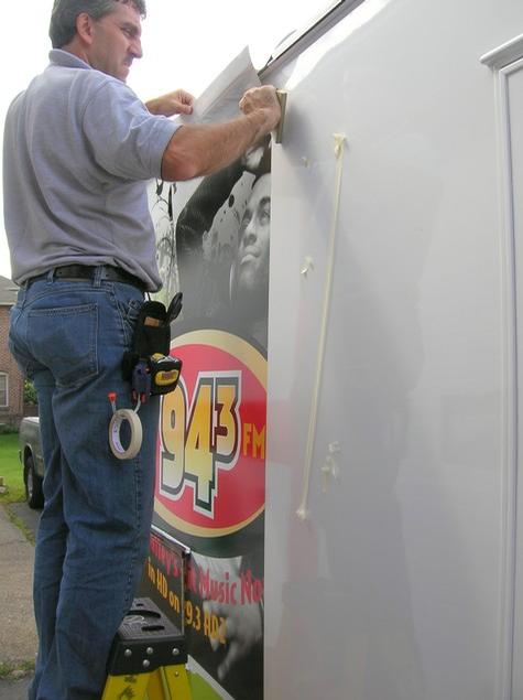Hits Now 94.3 — sign being fabricated on the bench by Hale Custom Signs