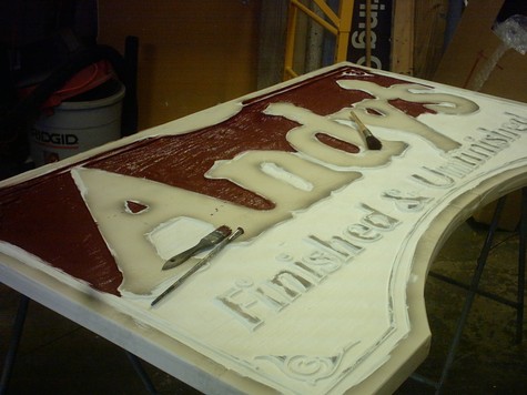 Sandblasting a dimensional sign blank on the bench at the Gill, MA shop