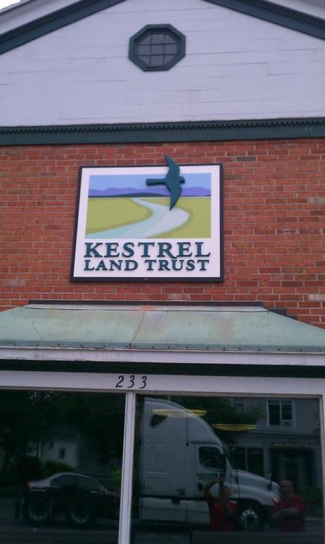 Kestral Land Trust - Custom dimensional letters on our custom backdrop mounted to brick facade — dimensional letter sign by Hale Custom Signs