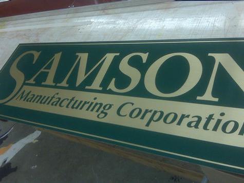 Brushed brass vinyl — trade show display by Hale Custom Signs